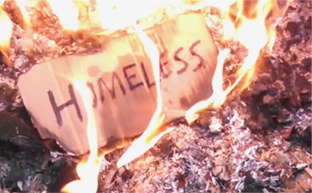 Homeless cardboard sign burning